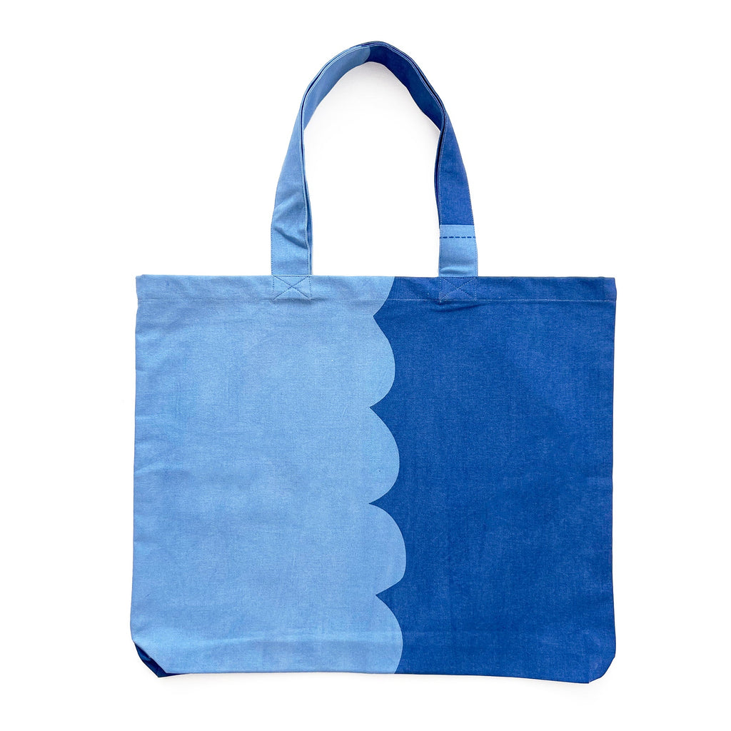 A lightweight blue Graphic Tote Bag with a scalloped edge by See Design.