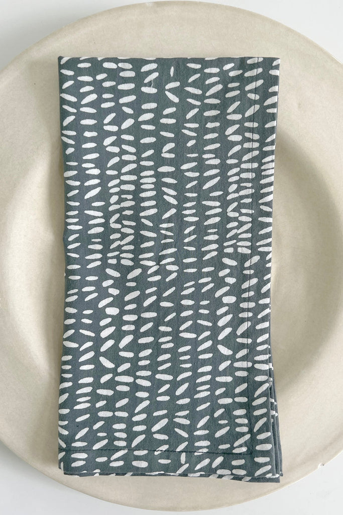 A See Design Napkins (Set of 4) on a white plate.