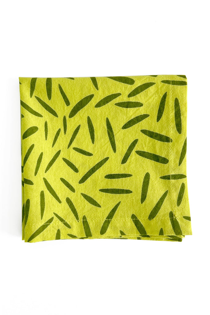 A vibrant yellow cocktail napkin (Set of 4) with hand painted green leaves by See Design.