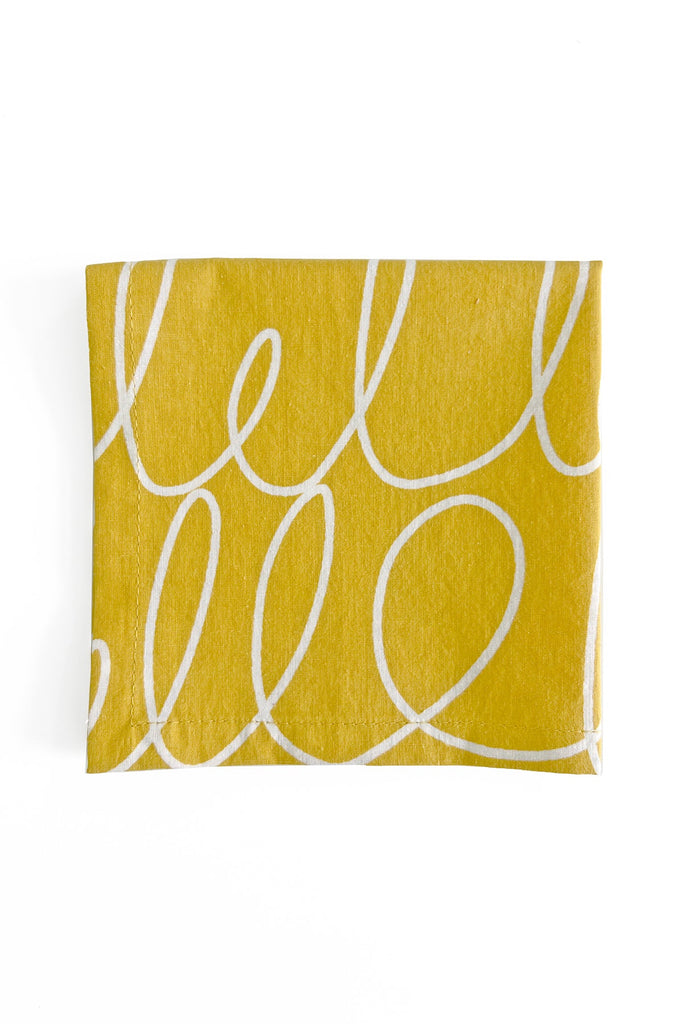 A See Design Cocktail Napkins (Set of 4) hand-painted yellow napkin with the word hello written on it.