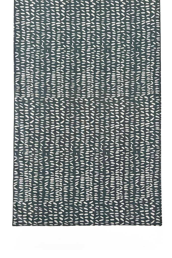 A See Design table runner with a pattern of wavy lines.