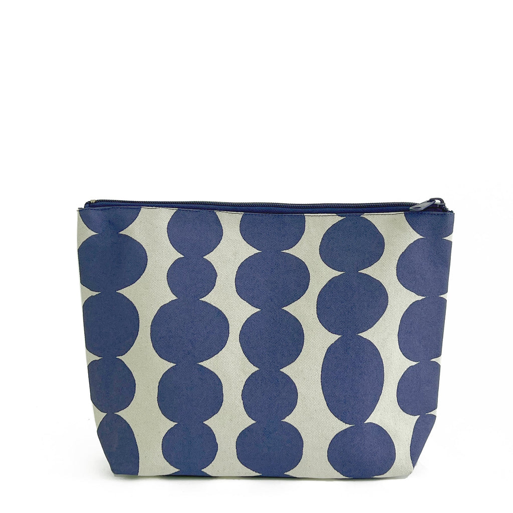 A See Design Travel Pouch Large with a blue and white polka dot 100% cotton canvas exterior for storing essentials.
