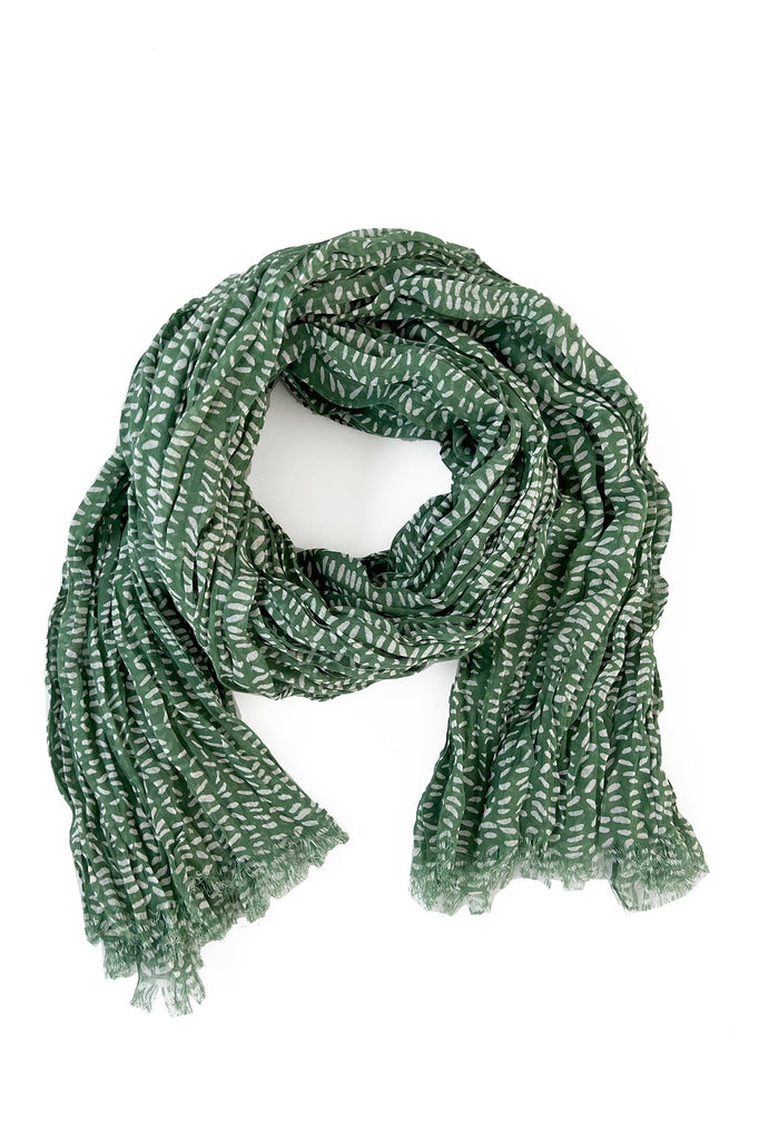 A green and white See Design cotton scarf on a white background.