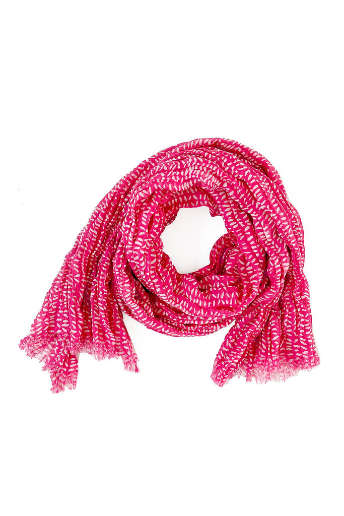 A pink lightweight Cotton Scarf by See Design on a white background.