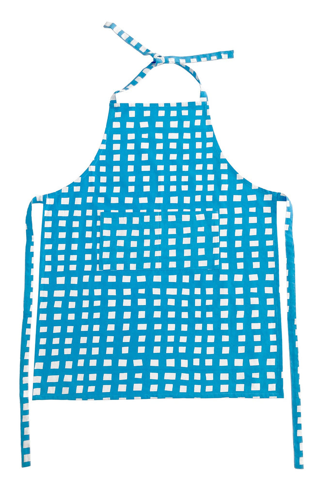 A See Design kitchen apron with hand-painted blue and white checkered designs on a white background.