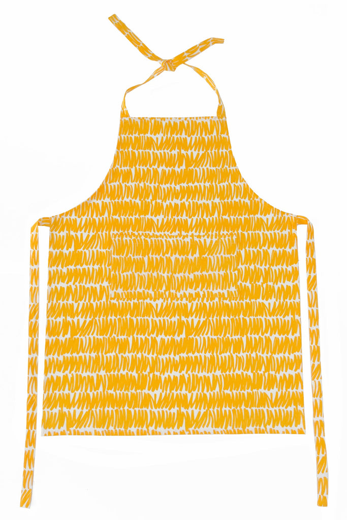 A See Design apron with hand-painted designs in a yellow color and a black and white pattern, perfect for cooking.