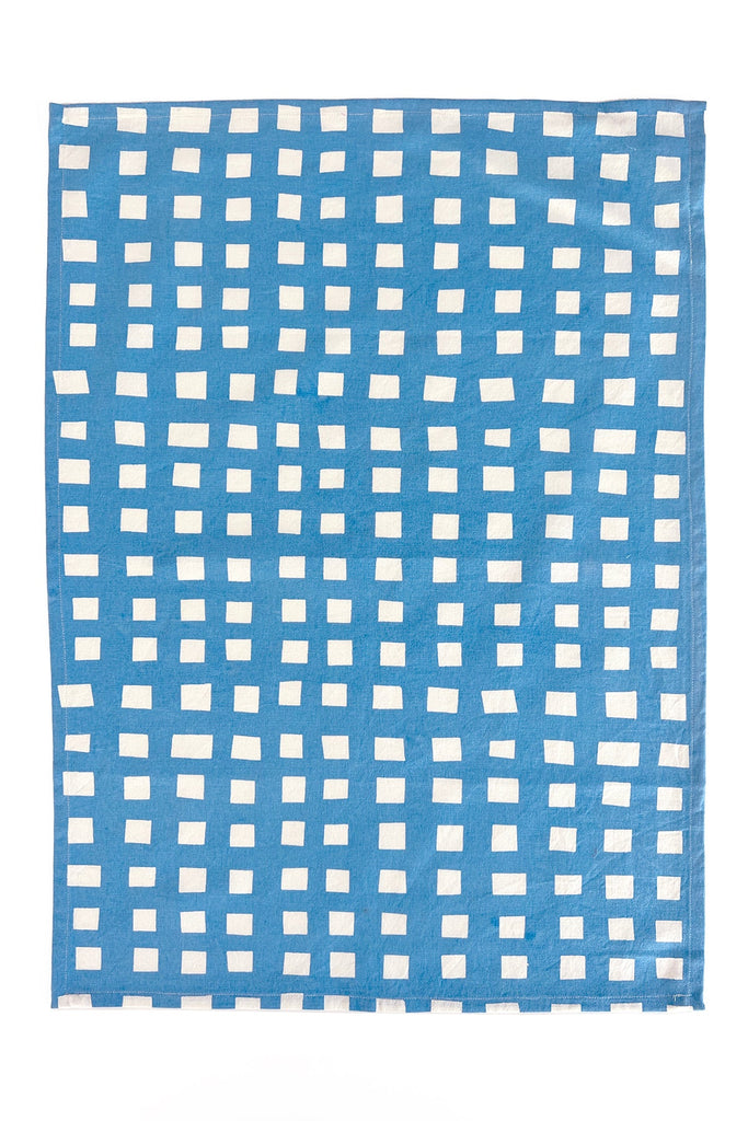 A vibrant blue and white square pattern on a white background, hand painted on See Design Tea Towels (Set of 2).