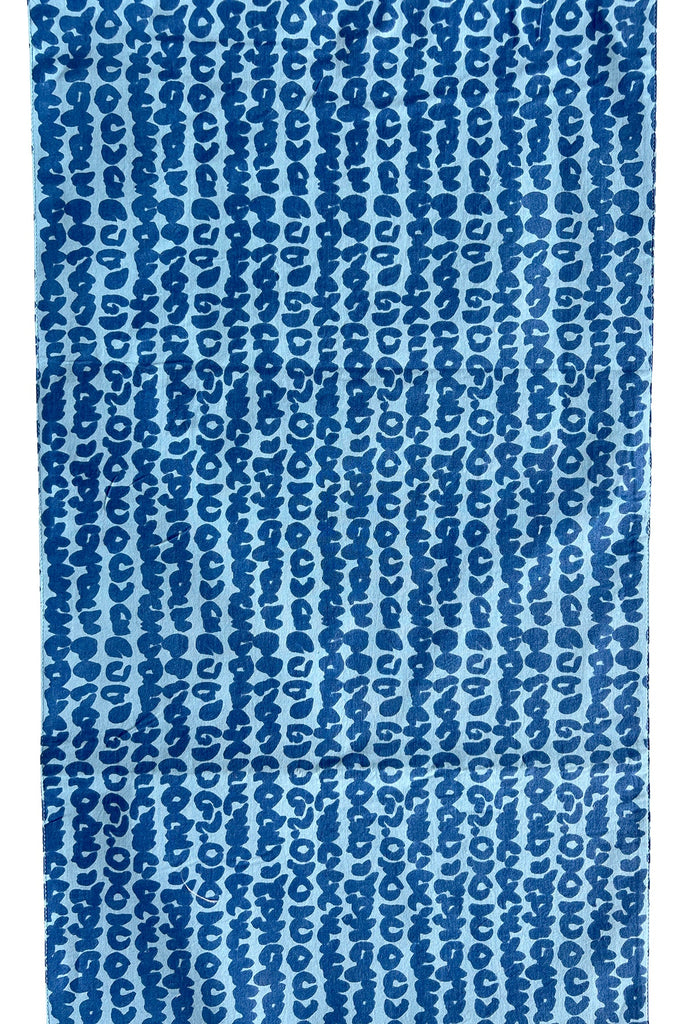 A blue and white Table Runner with a pattern of prints and colors from See Design.
