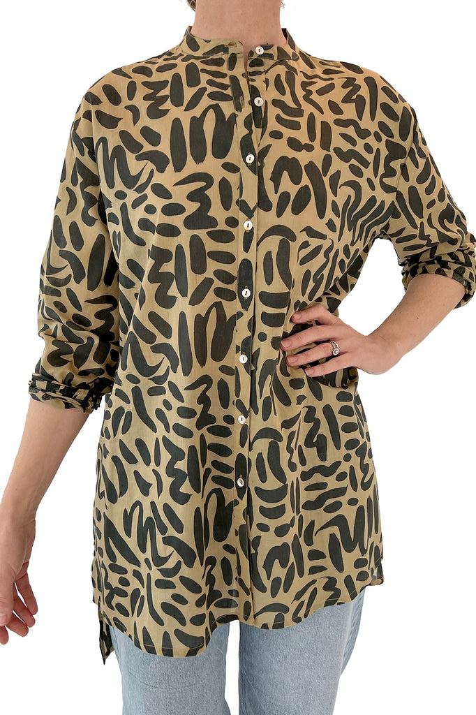 A fashionable woman wearing a comfortable See Design long shirt with animal print.