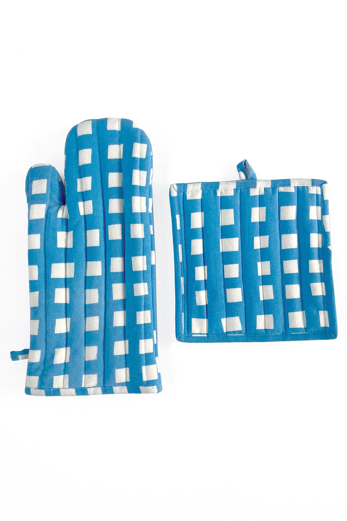 A pair of hand-painted blue and white See Design Oven Mitt & Potholder Set on a white surface.