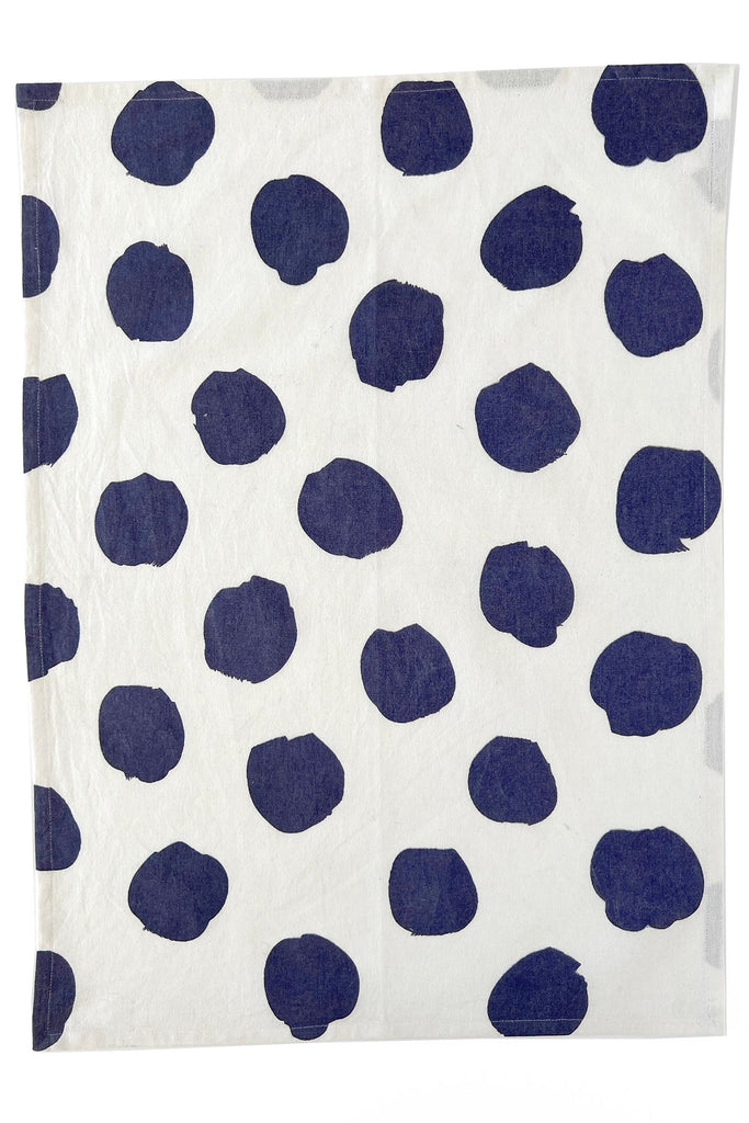 A vibrant blue and white polka dot See Design tea towel (set of 2) in a kitchen setting.