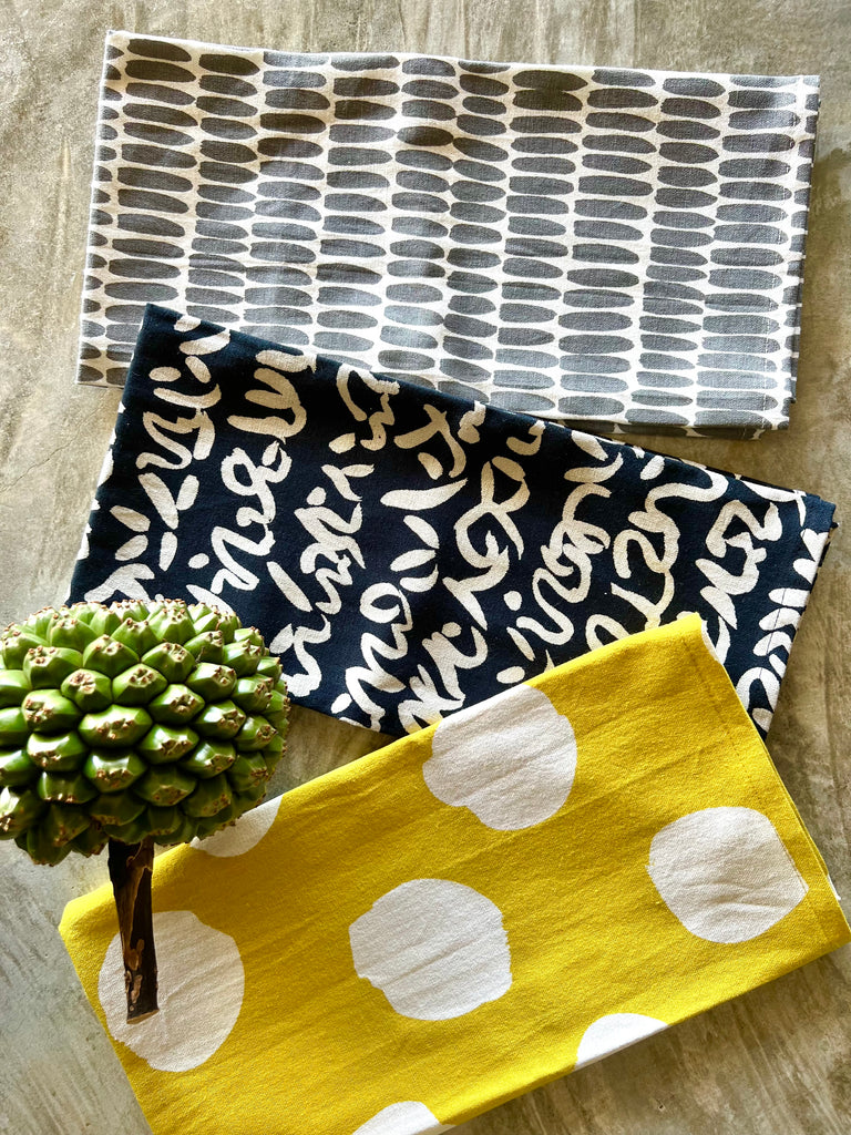 Three colorful See Design tea towels (set of 2) with polka dot designs, perfect for a kitchen setting.