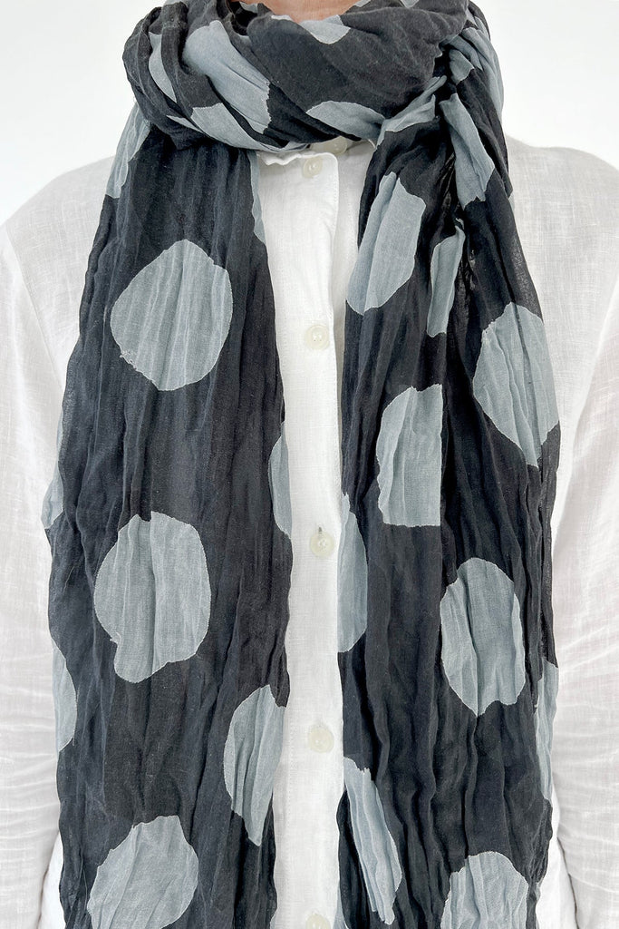 A woman wearing a crinkled lightweight See Design cotton scarf.
