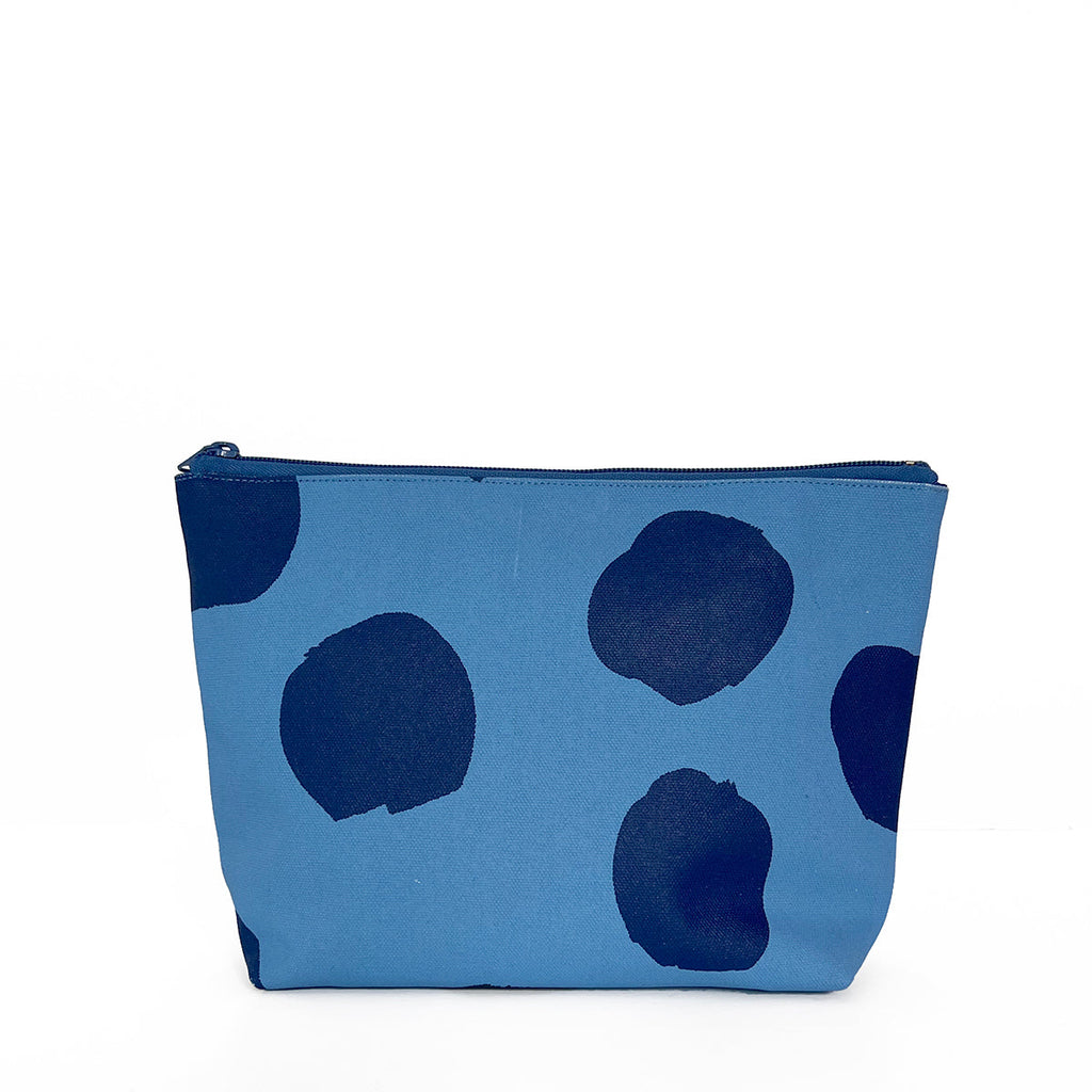 A large Travel Pouch Large in blue and black polka dots, perfect as a travel accessory by See Design.
