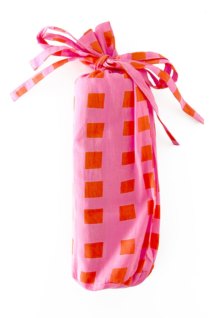 A fashionable Sarong bag with a ribbon tied around it from See Design.