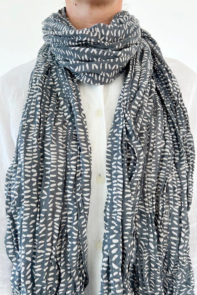 A woman wearing a delicately crinkled See Design cotton scarf.