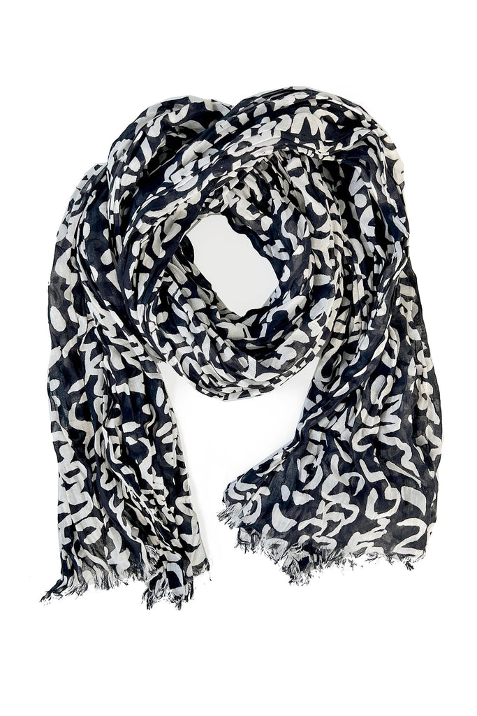 A lightweight black and white See Design cotton scarf with a floral pattern.