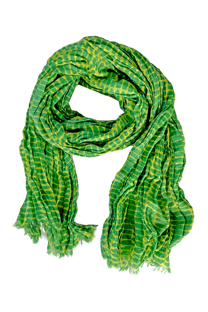 A lightweight See Design cotton scarf with a crinkled texture, featuring green and yellow colors on a white background.