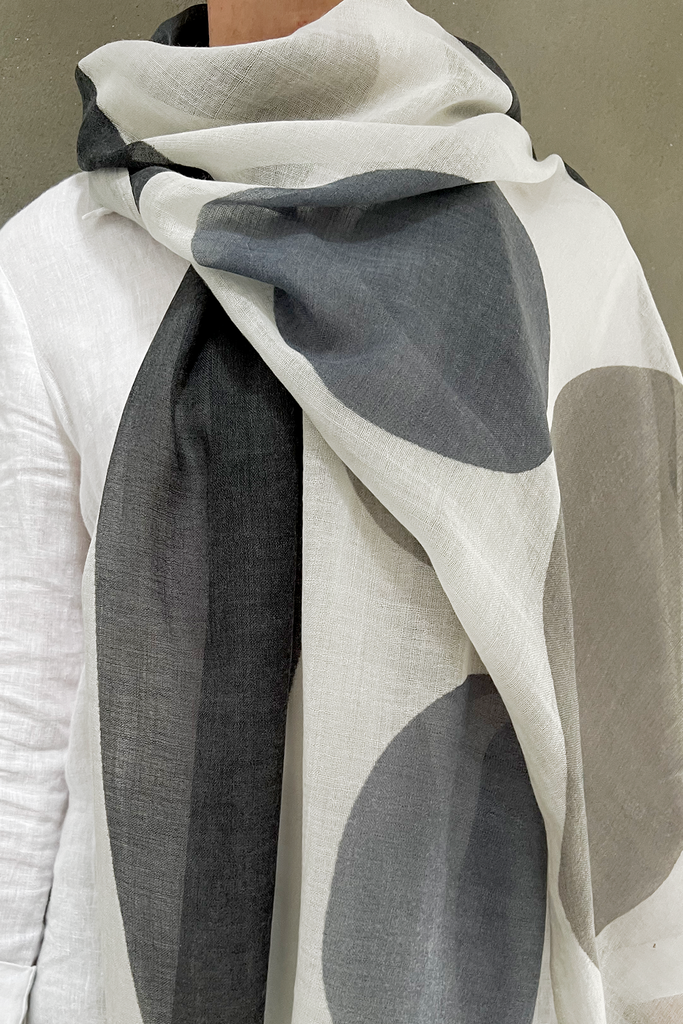 A woman wearing a See Design wool scarf.