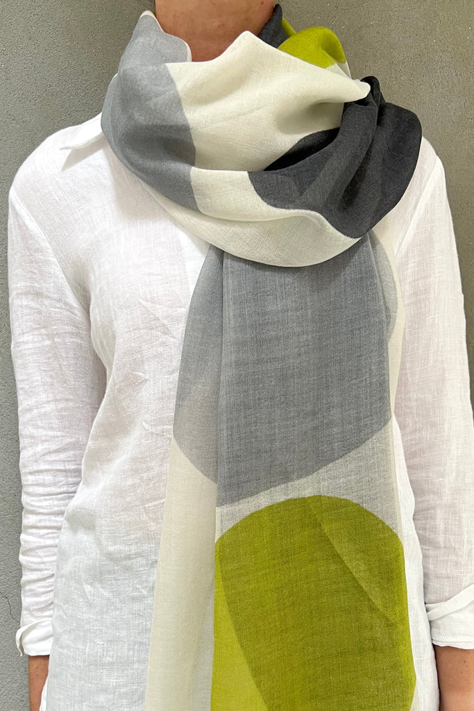 A woman wearing a See Design wool scarf.