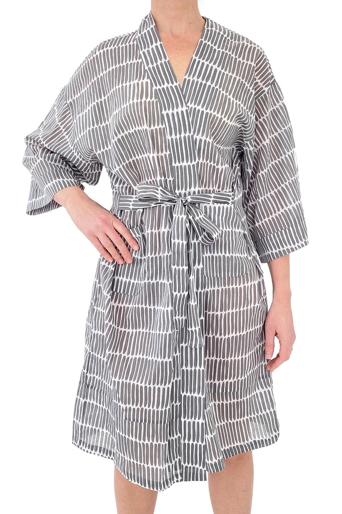 A woman wearing a lightweight cotton voile striped Kimono robe by See Design.