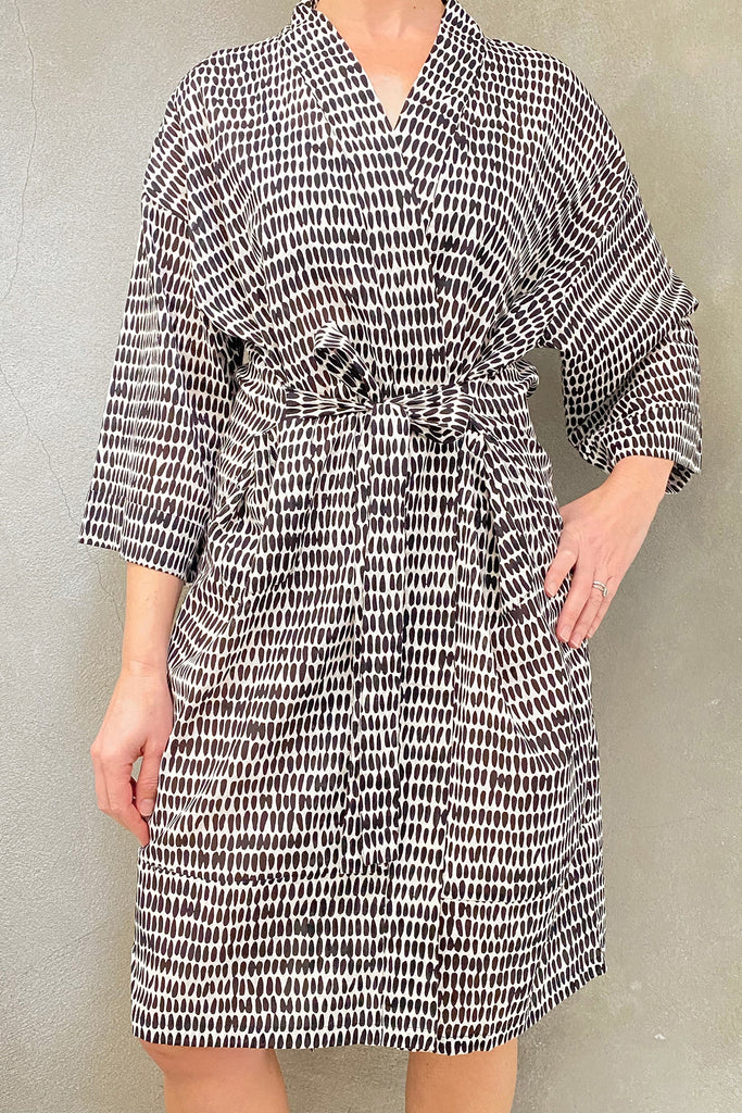 A woman wearing a lightweight See Design kimono robe.