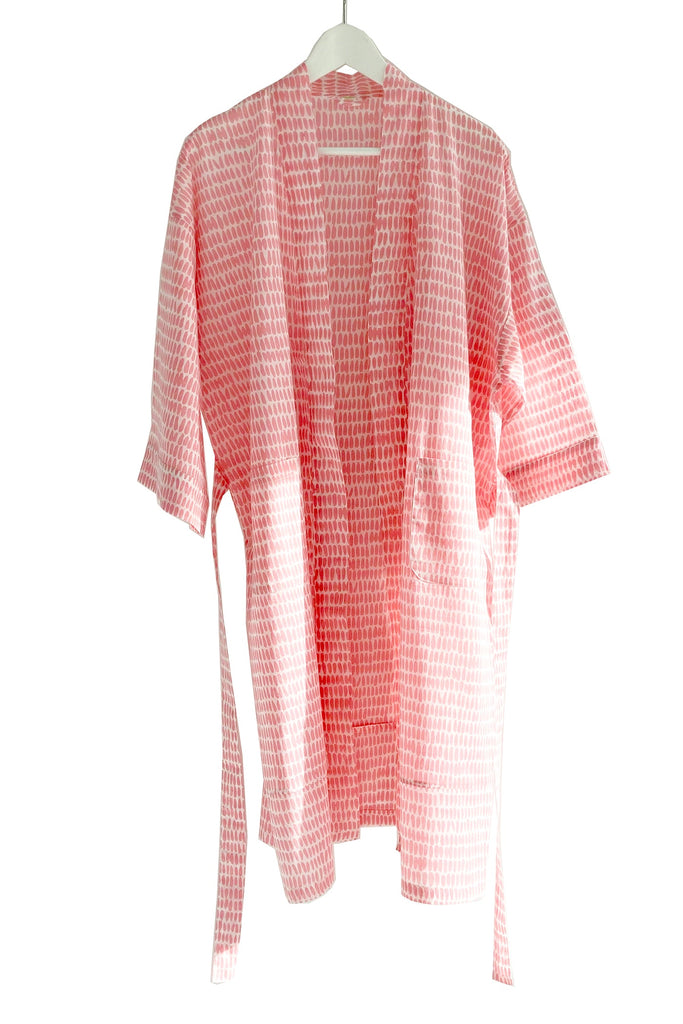 A lightweight See Design kimono robe in pink and white stripes, made of cotton voile.