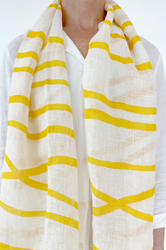 A woman wearing a See Design Linen Scarf.