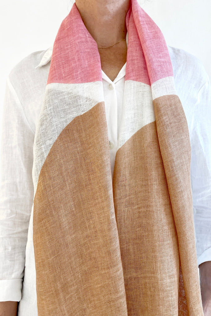 A woman wearing a See Design linen scarf.