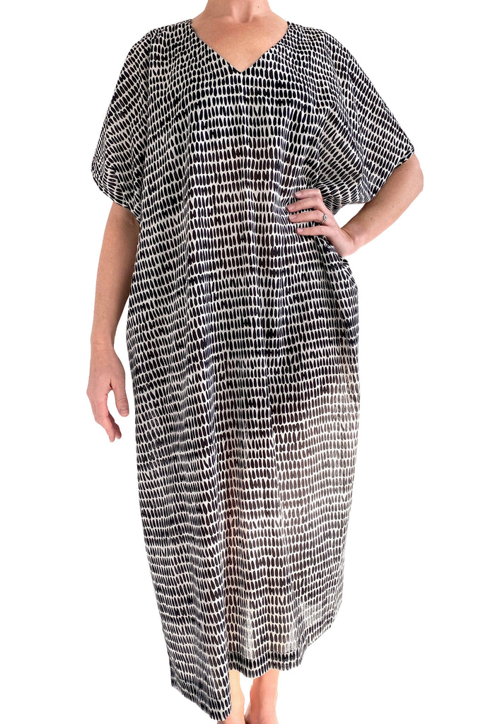 A woman wearing a See Design Caftan Long beach cover up.