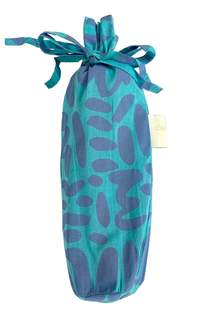 A fashionable teal and blue Sarong bag with a lightweight cotton ribbon tied around it by See Design.