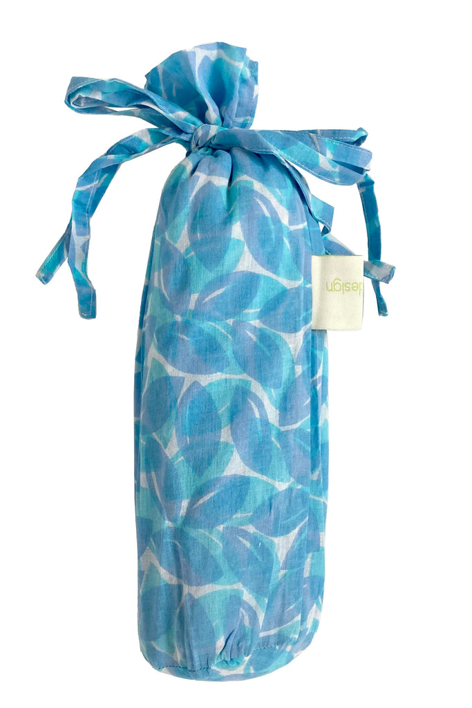 A fashionable Sarong bag with a light blue and white design tied with a ribbon by See Design.