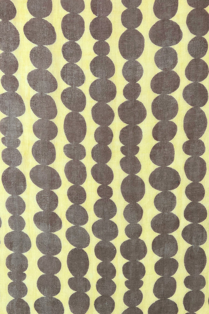A colorful See Design linen scarf with dots on a modern design element.