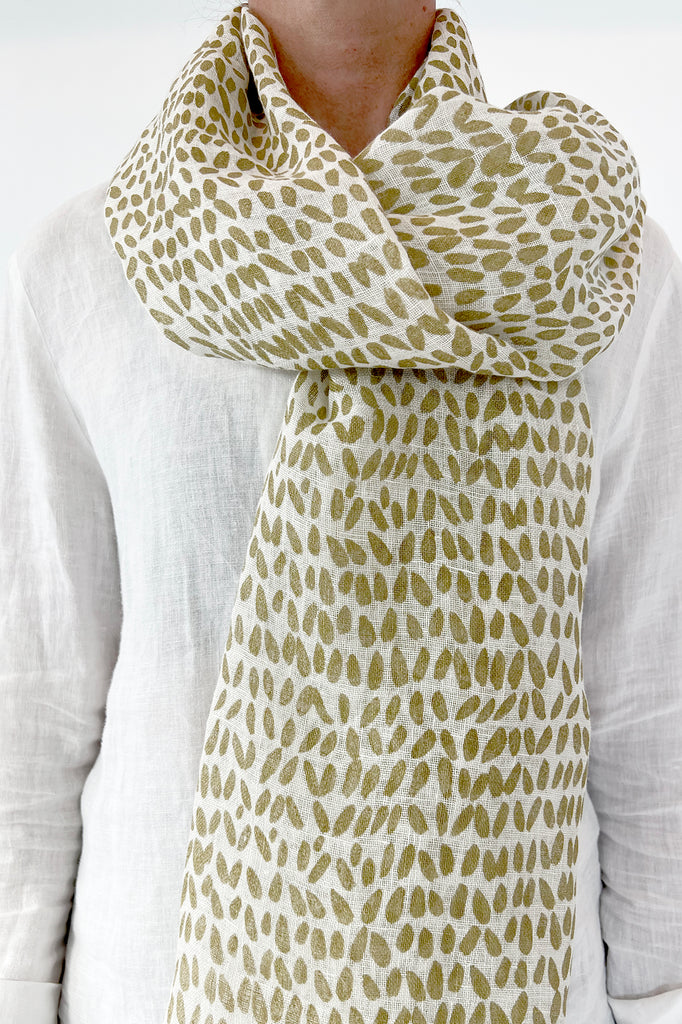 A woman wearing a See Design linen scarf.