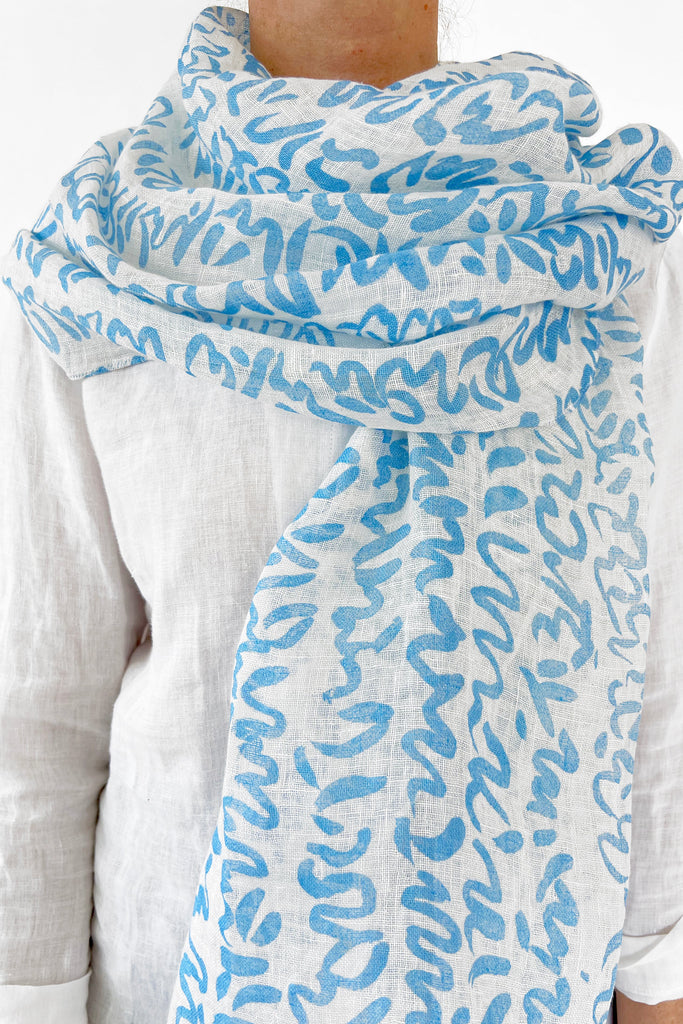 A woman wearing a See Design linen scarf.