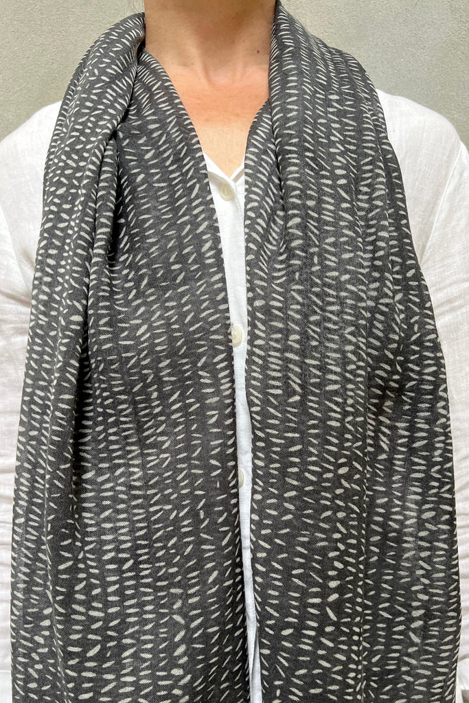 A woman wearing a See Design Wool Scarf.