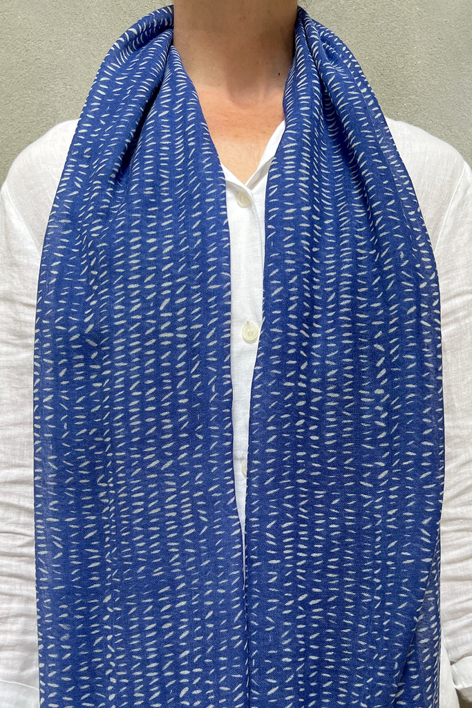 A woman wearing a See Design wool scarf.