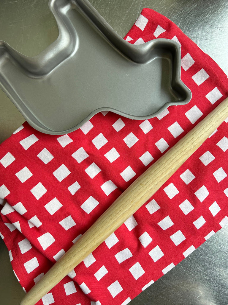 A set of 2 Tea Towels (See Design) adorned with vibrant patterns on a table.