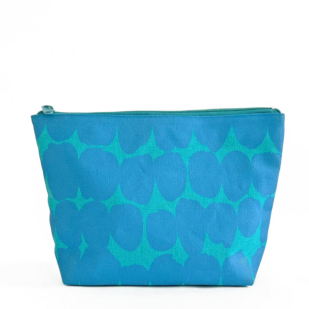 A large Travel Pouch Large in blue and green on a white background by See Design.