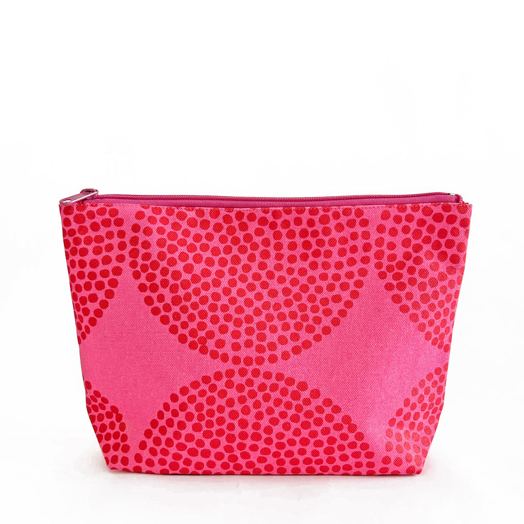 A See Design large travel pouch with polka dots on it.