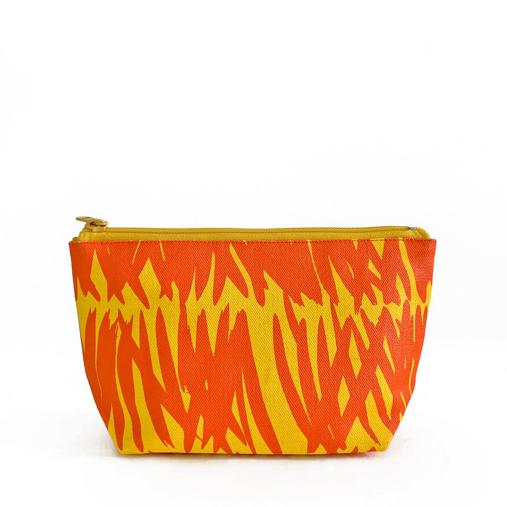 An orange and yellow zebra print See Design small travel pouch for essentials.