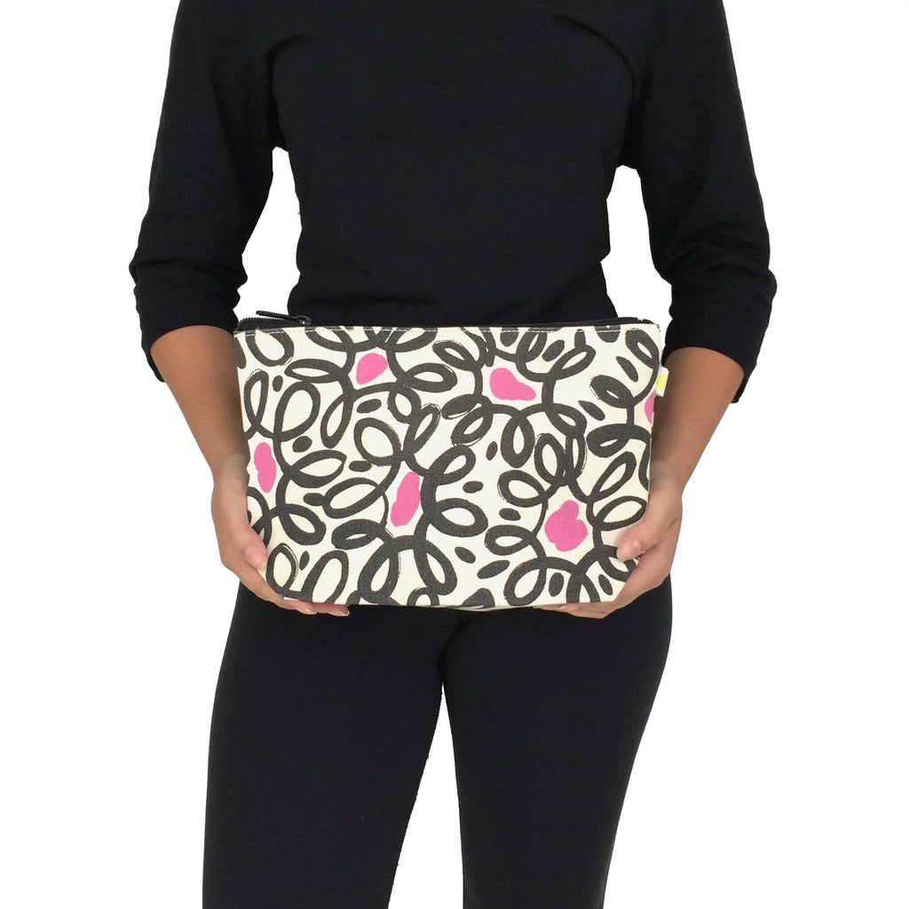 A woman is holding a See Design Travel Pouch Large.