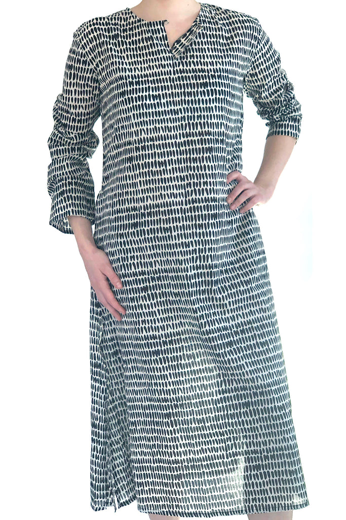 A woman wearing a lightweight, full length cotton voile See Design tunic dress.