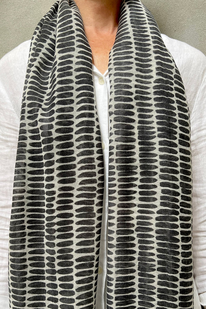 A woman wearing a See Design wool scarf.