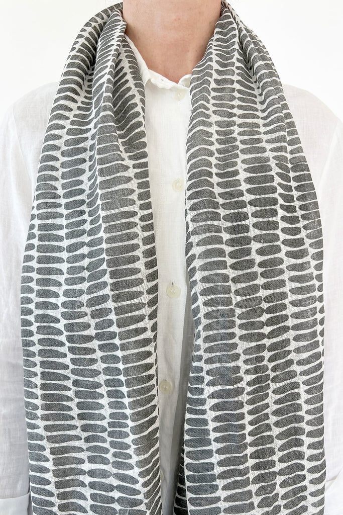 A woman wearing a See Design linen scarf.